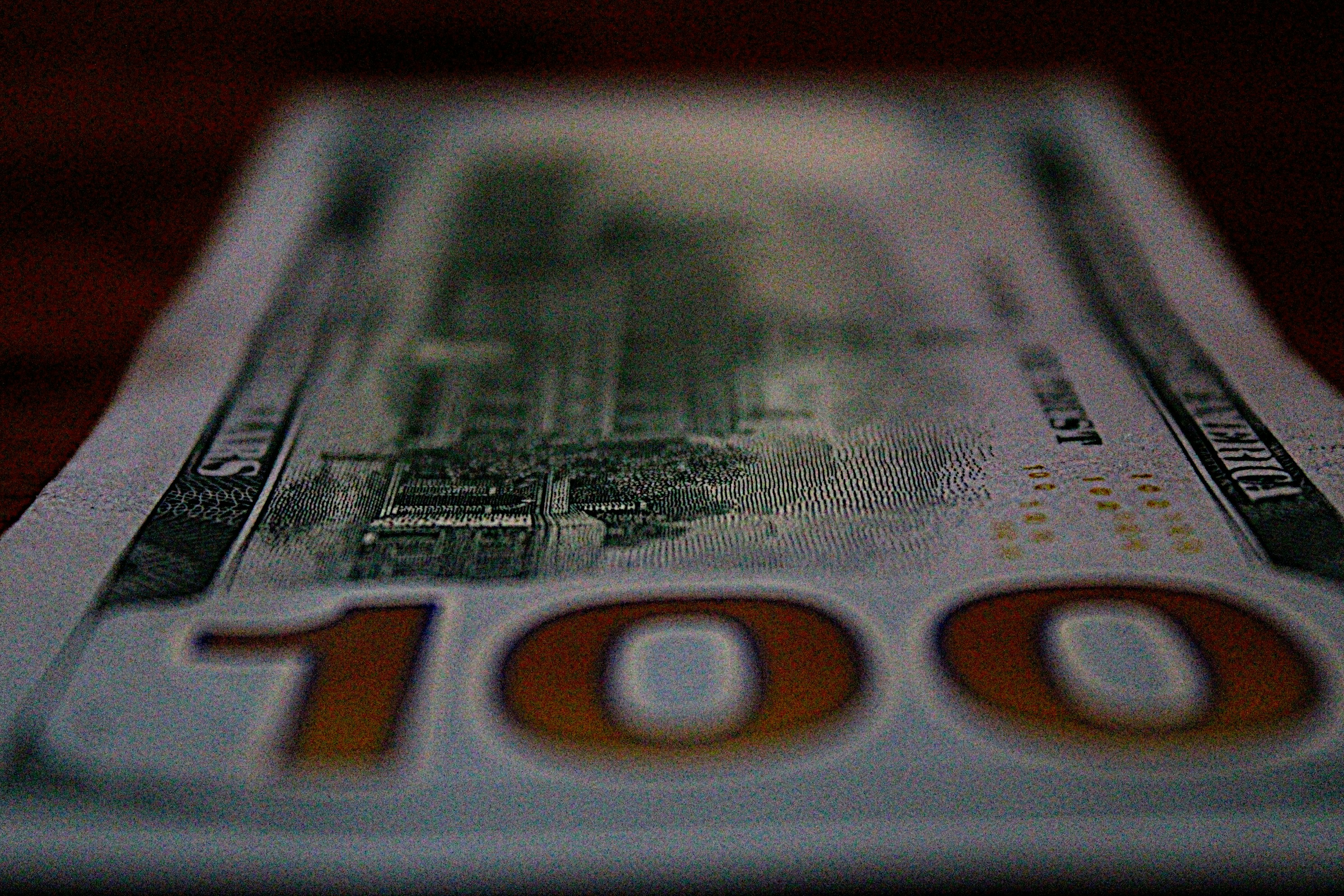 a hundred dollar bill with the number 100 on it